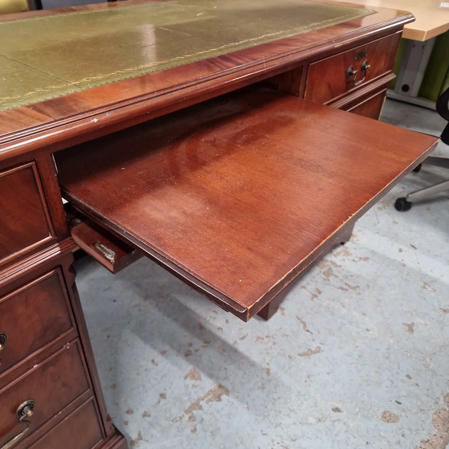 Ornate reproduction mahogany partners desk with drawers and green and gold emobossed leather top