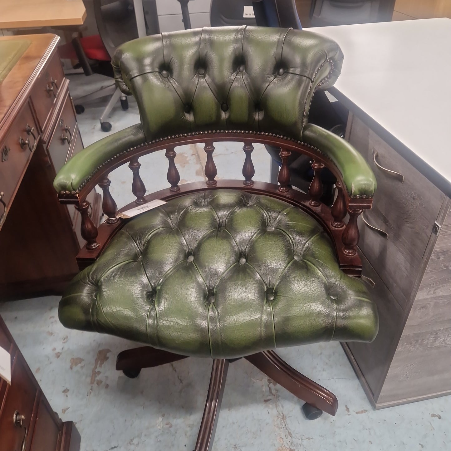 Chesterfield green leather button back swivel captains chair with wooden swivel base and arms