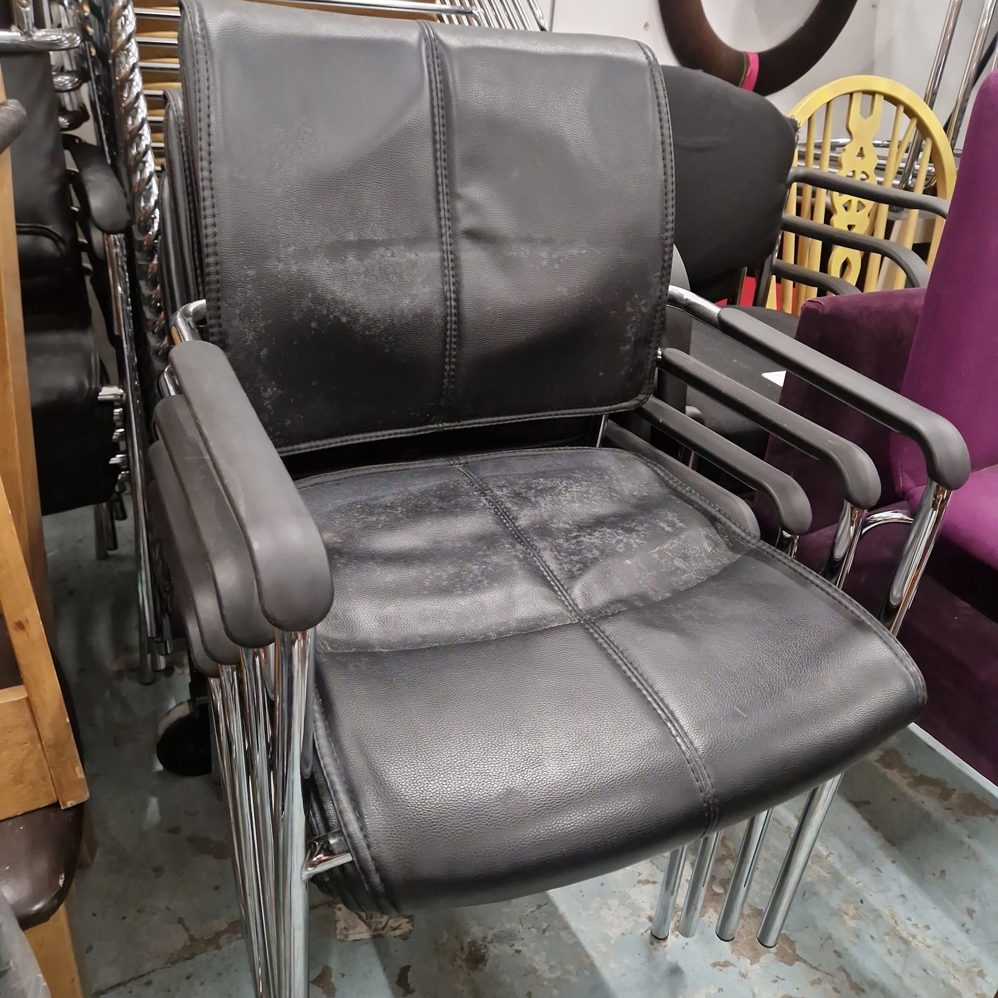 USED Black leatherette cantilever meeting chair with arms, polished chrome base, stackable