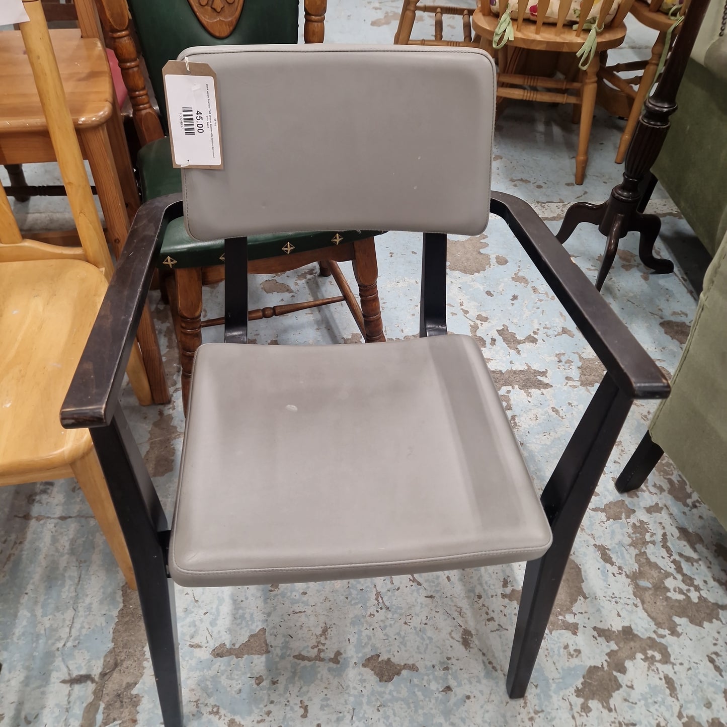 Solid wood black stained carver dining chair with arms, leather seat and back