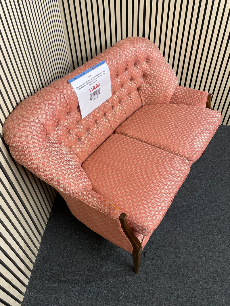 Two-seater sofa with pink geometric pattern and tufted backrest with slight wear to arm on LHS, solid wood frame. Ideal for