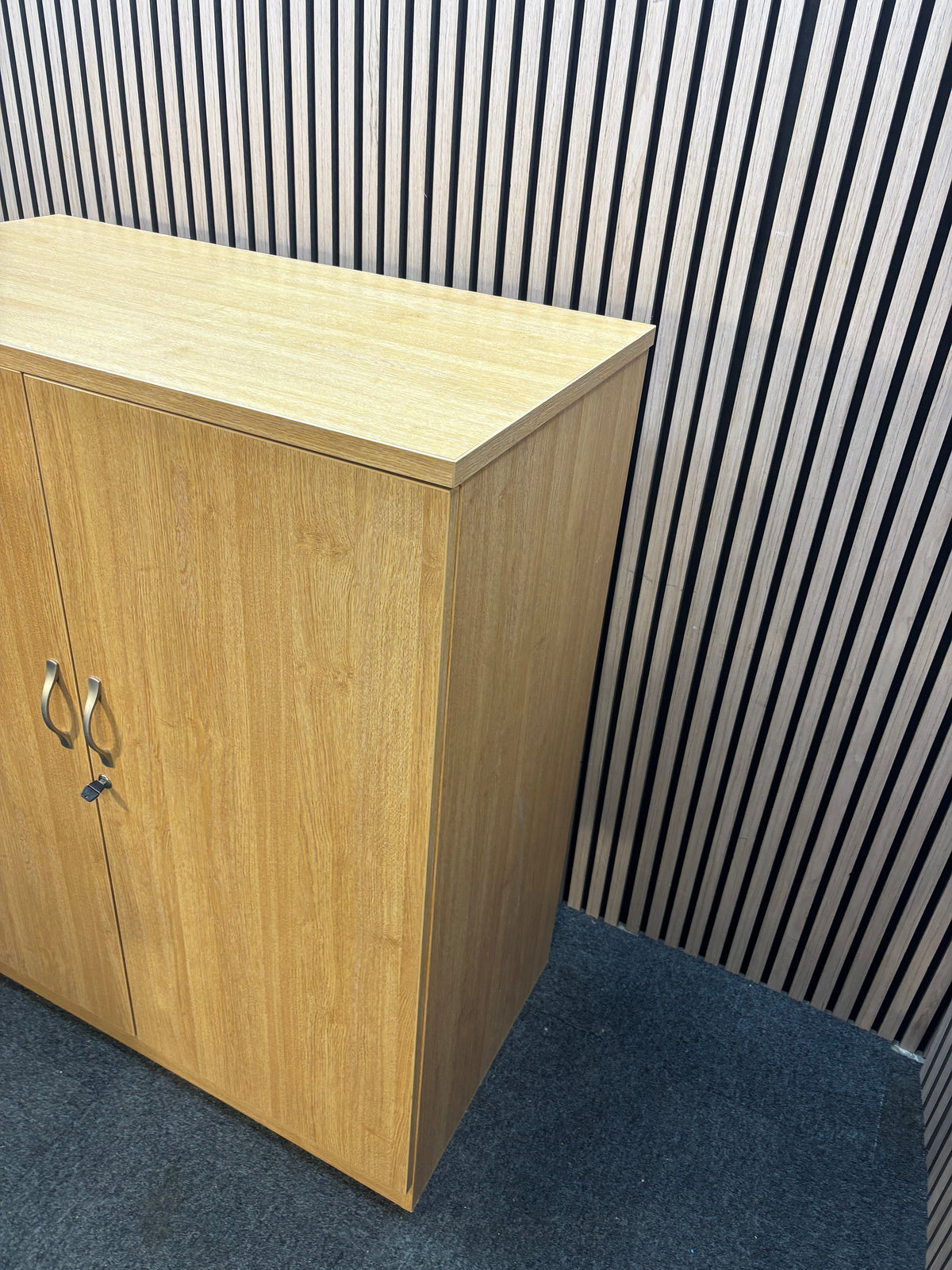 Medium 2 door oak laminate storage unit with internal metal shelves and handles. 120Hx102Wx55D  J3920