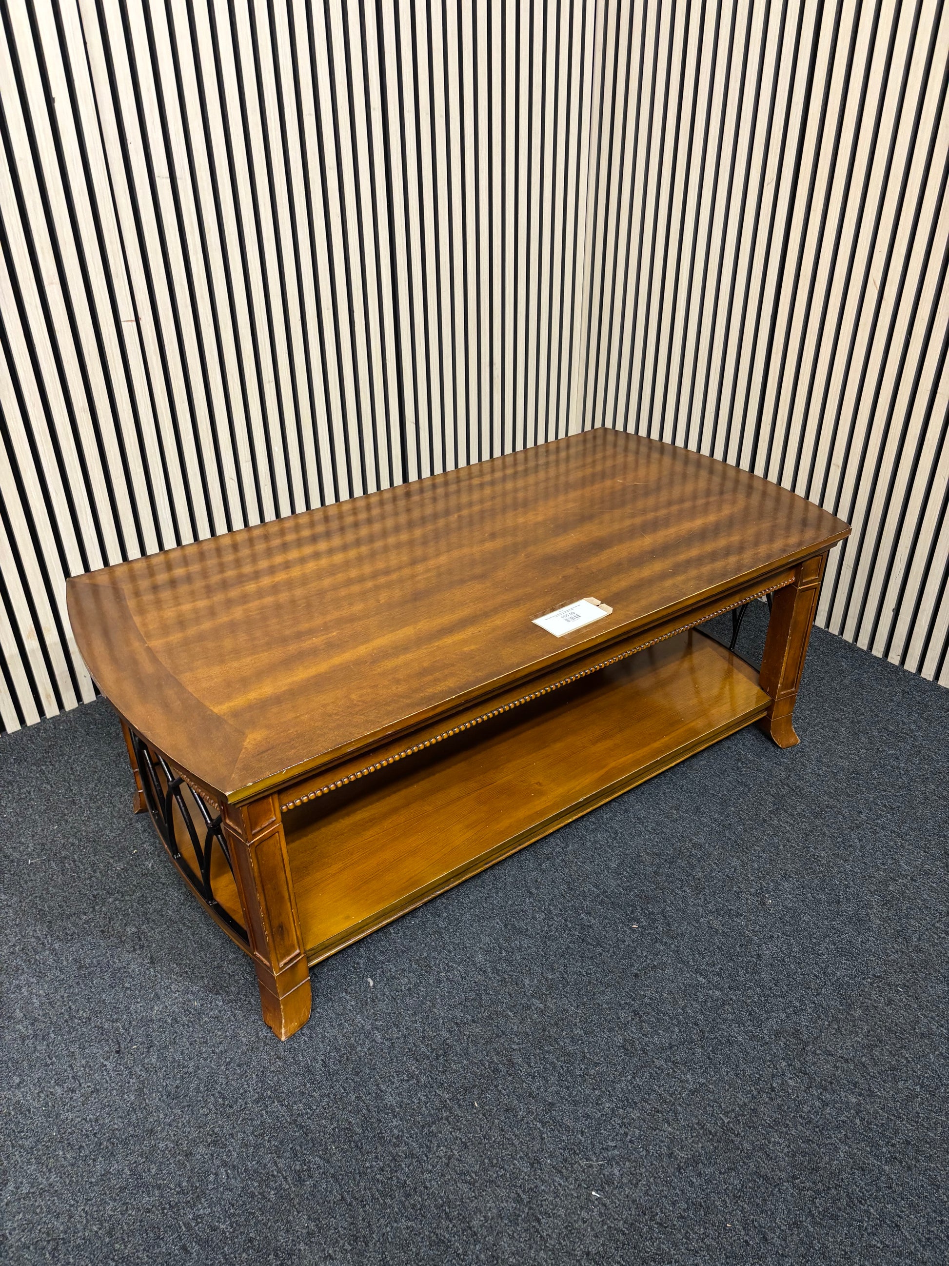 Solid dark wood stained low rectangular coffee table with ornate black metal details 2425