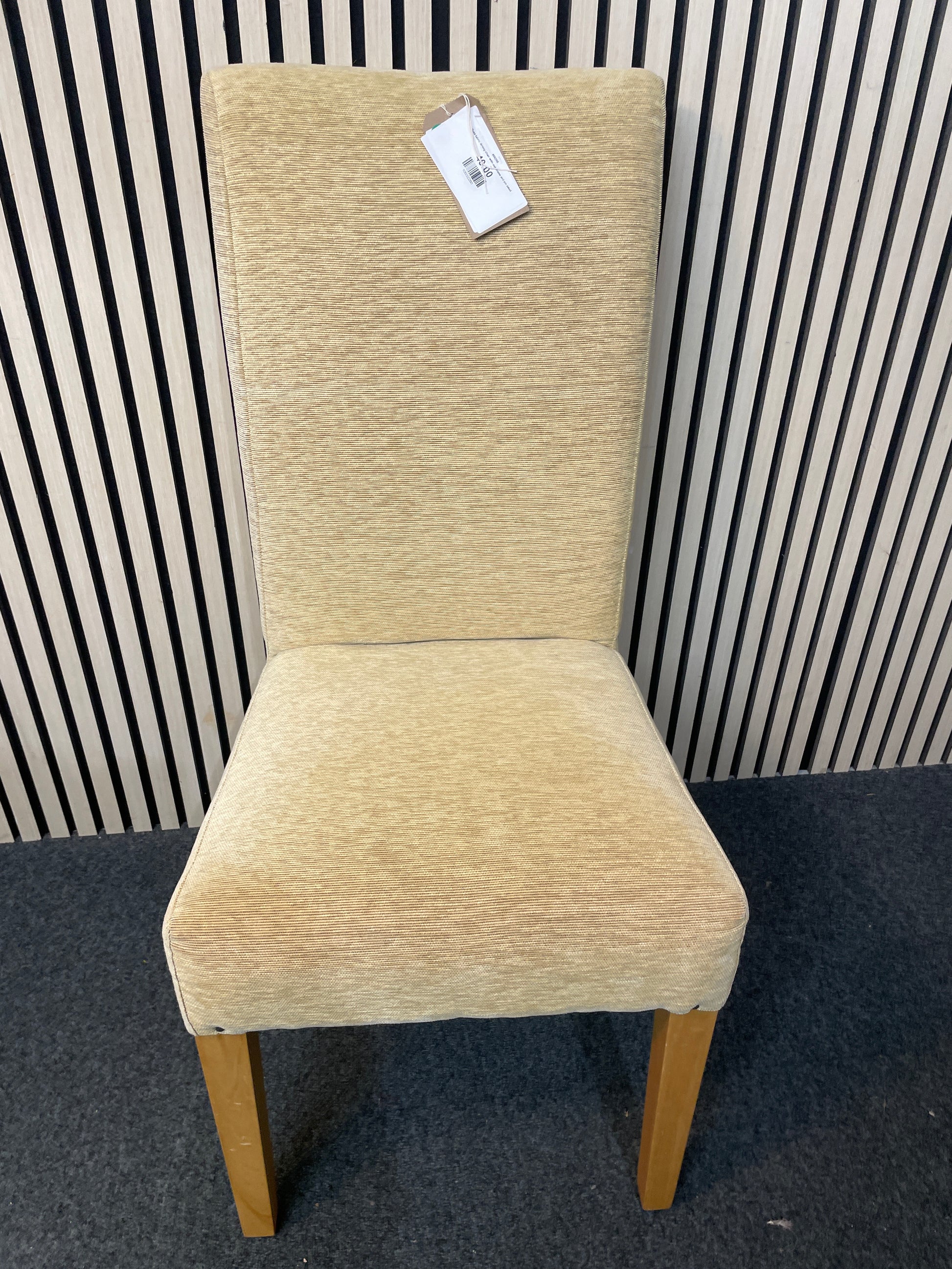 Gold fabric dining chair with oak frame and pin detail