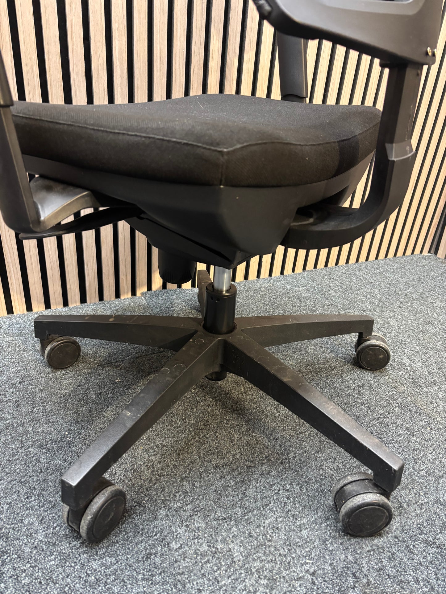 Black mesh back swivel chair with adjustable arms and 5 star swivel base