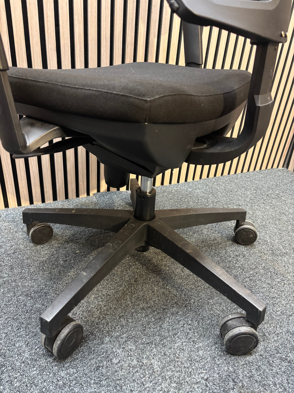 Black mesh back swivel chair with adjustable arms and 5 star swivel base