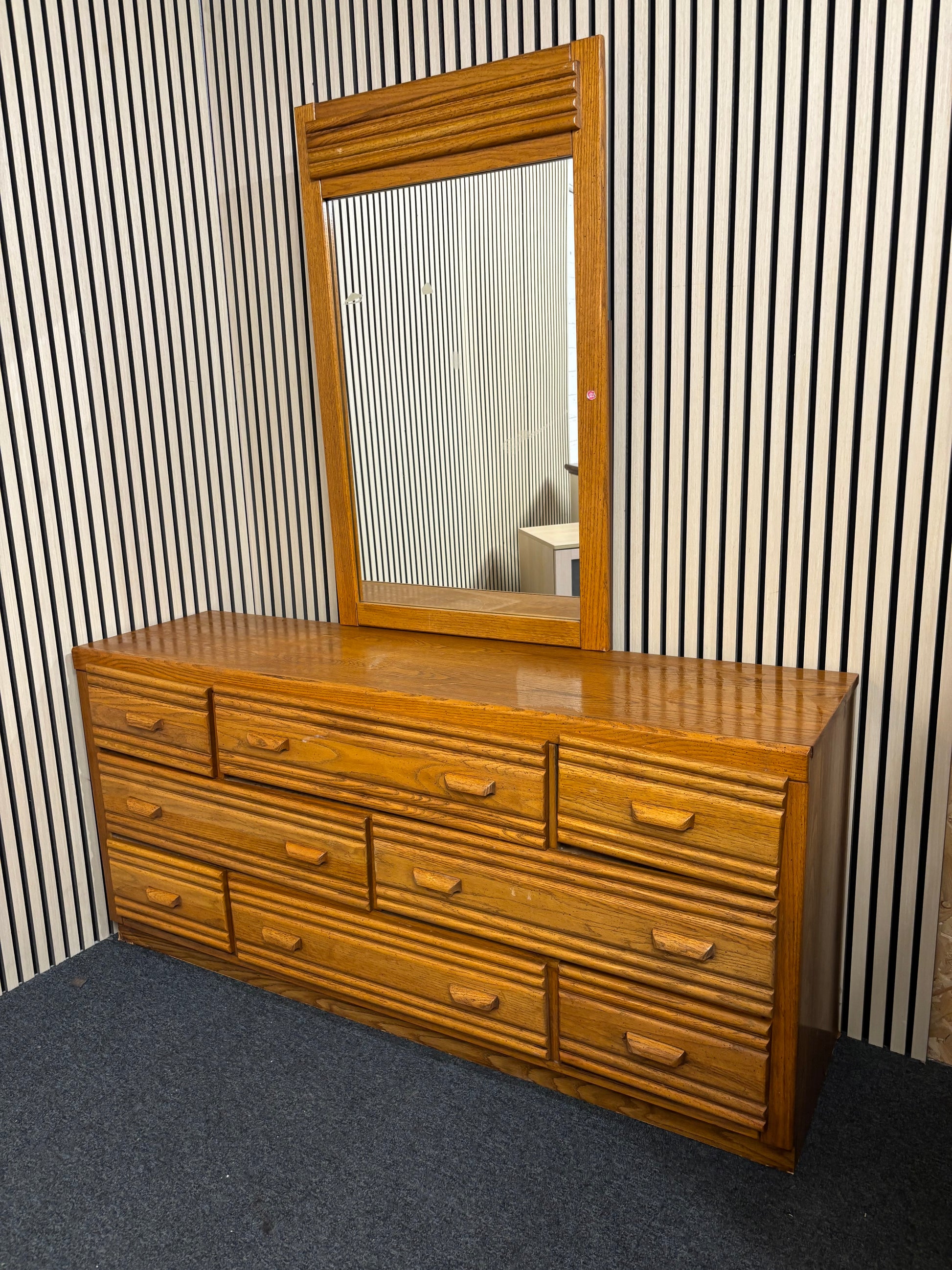 Large wooden 8 door dresser with a matching framed mirror