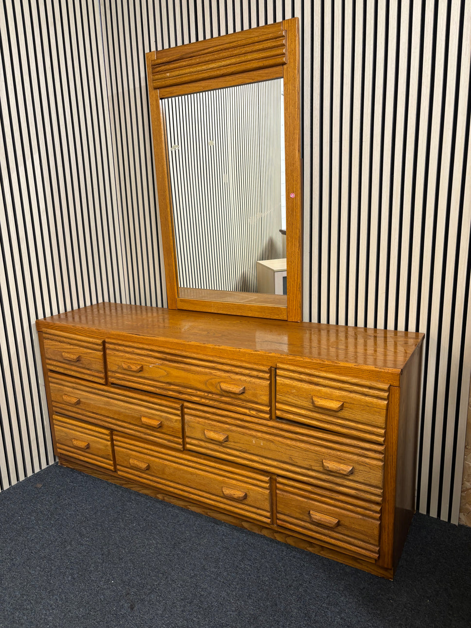Large wooden 8 door dresser with a matching framed mirror