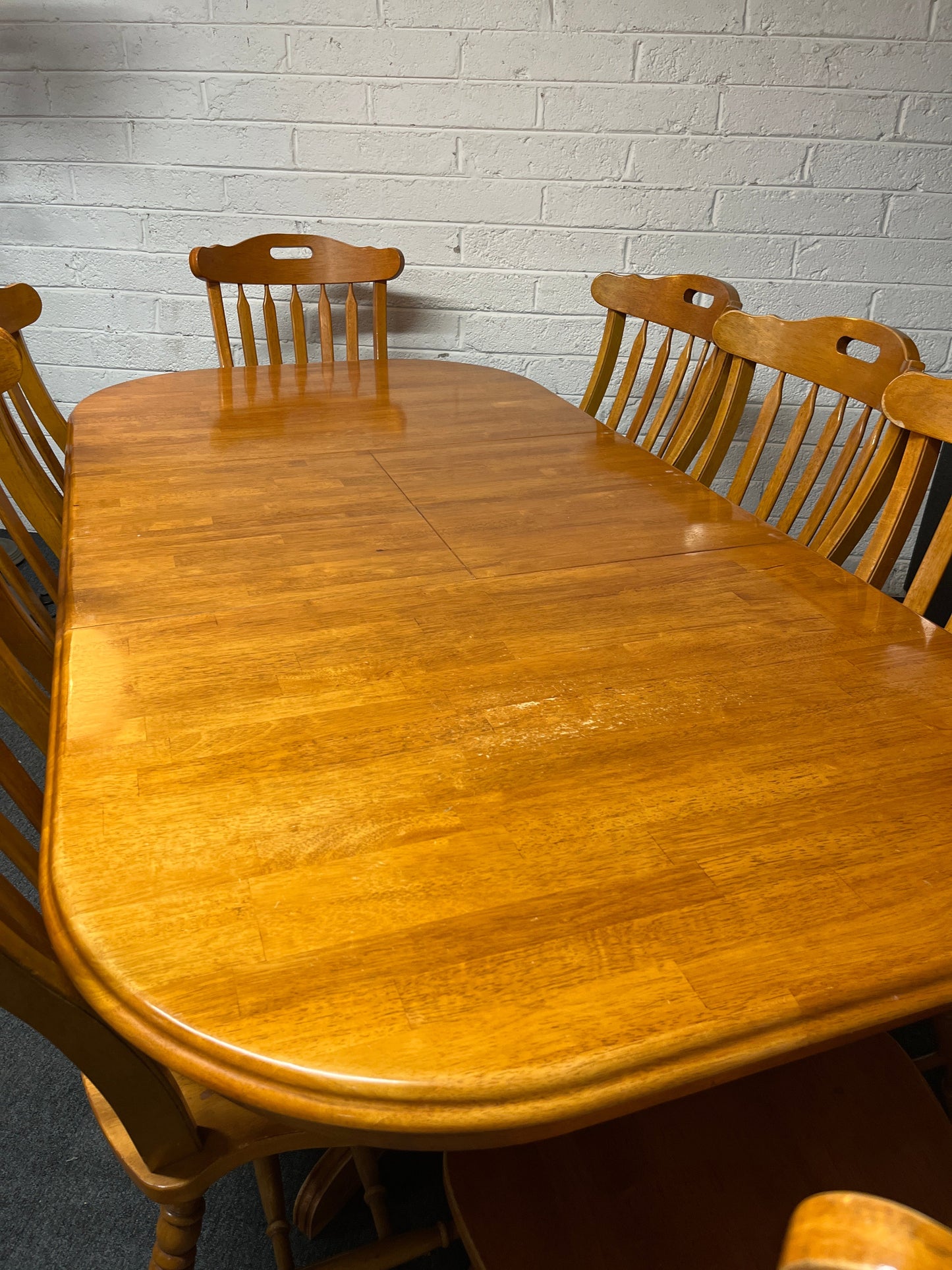 Large hardwood oval extendable dining table (L 155 - 215 x W 105 cm) with 8 no. matching high back solid wood chairs 2225