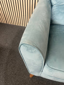A modern duck egg blue velvet armchair with piped edges.  44696