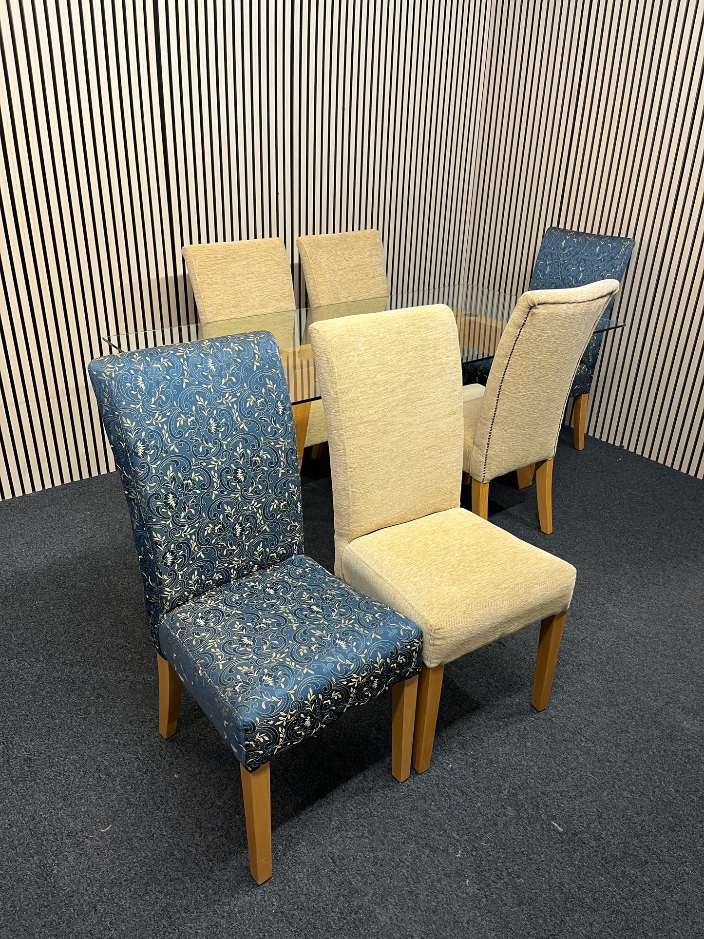 Long glass rectangular dining table(W 180 x D 90 cm) with 4 no. high back brown fabric dining chairs and 2 no. navy and gold fabric end chairs