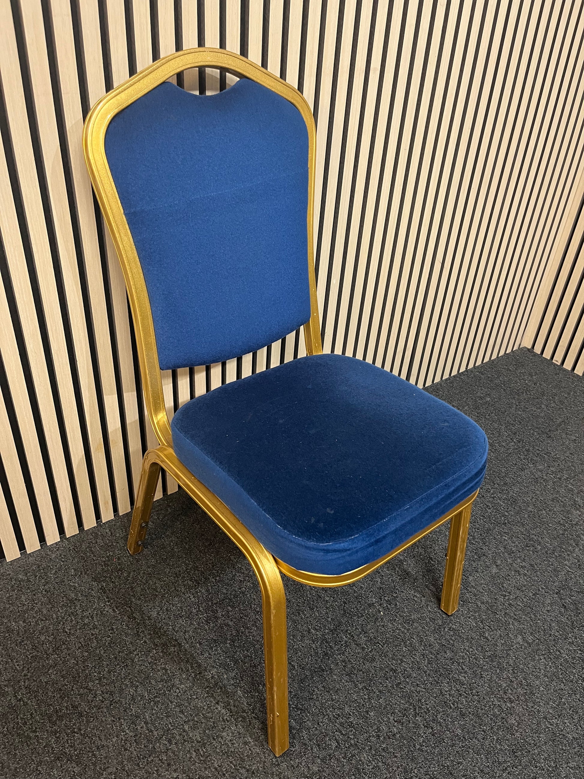 Blue fabric metal framed gold effect stacking banquet chair with curved top