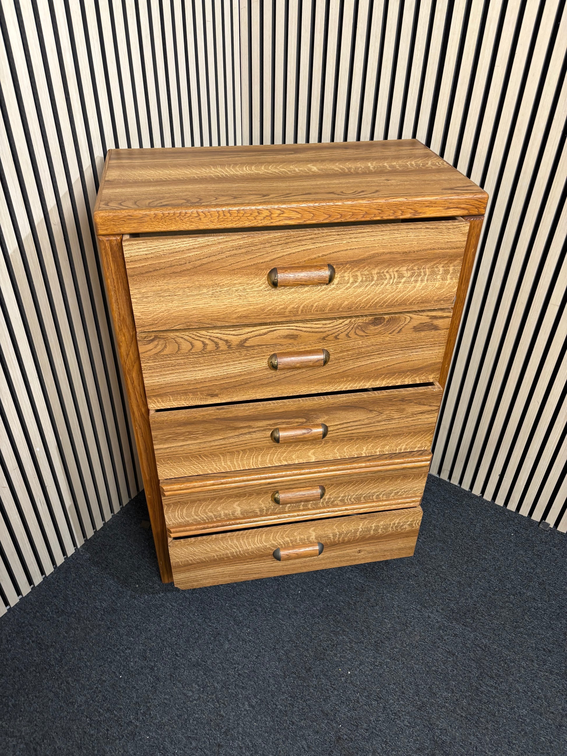 Tall wooden chest with five drawers and rounded handles