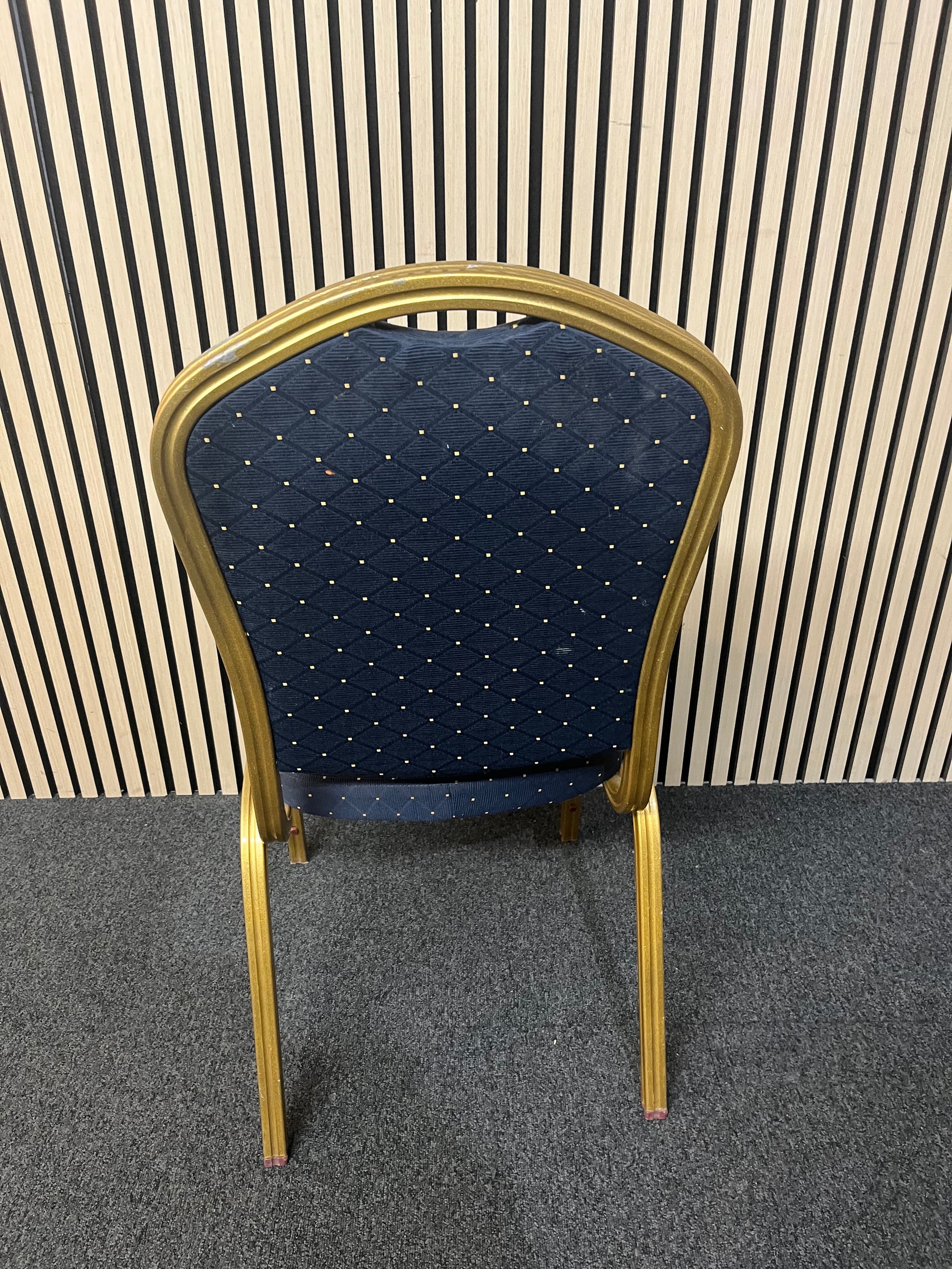 Blue patterned fabric banquet stacking chair with gold effect metal frame