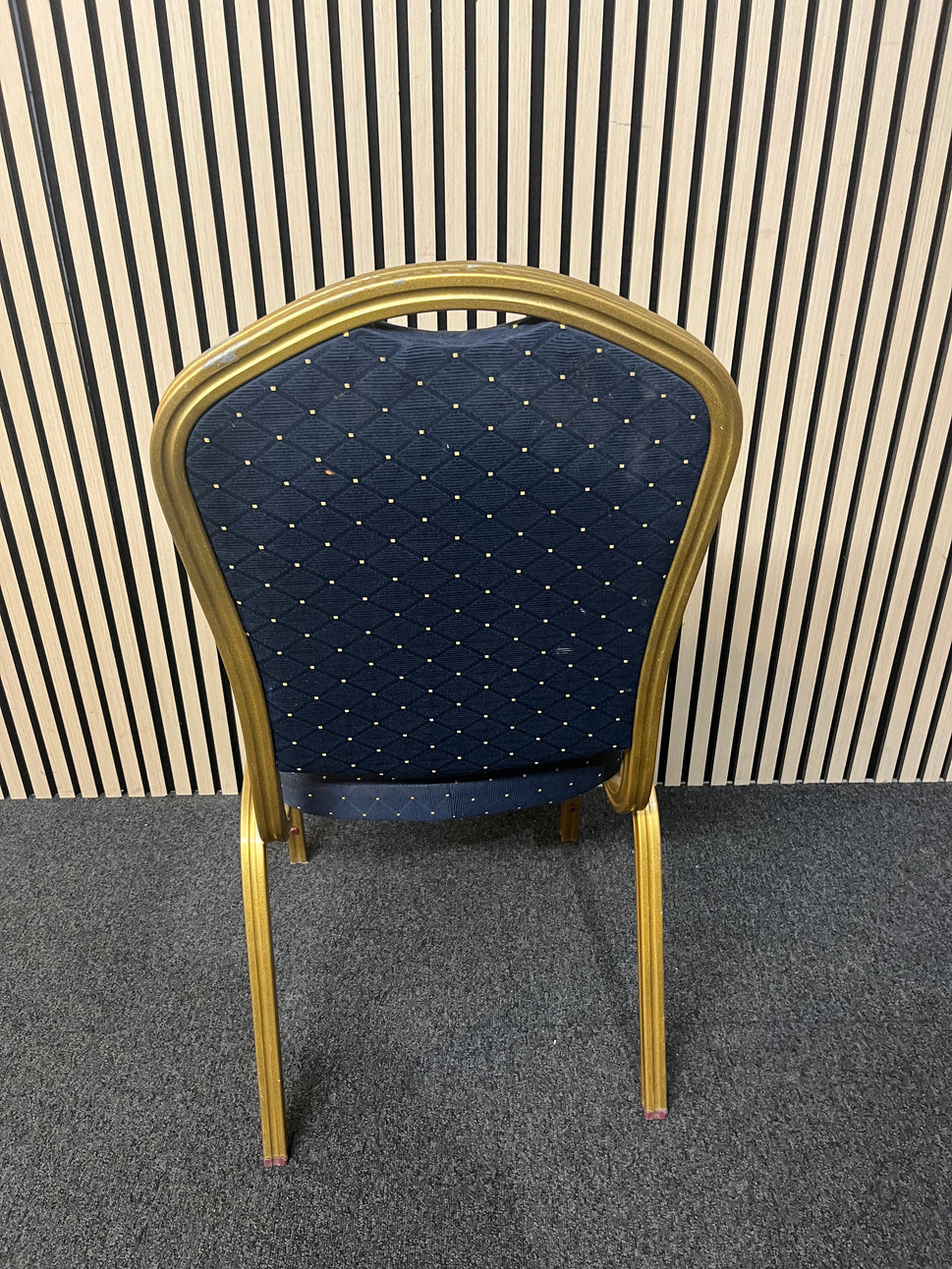 Blue patterned fabric banquet stacking chair with gold effect metal frame