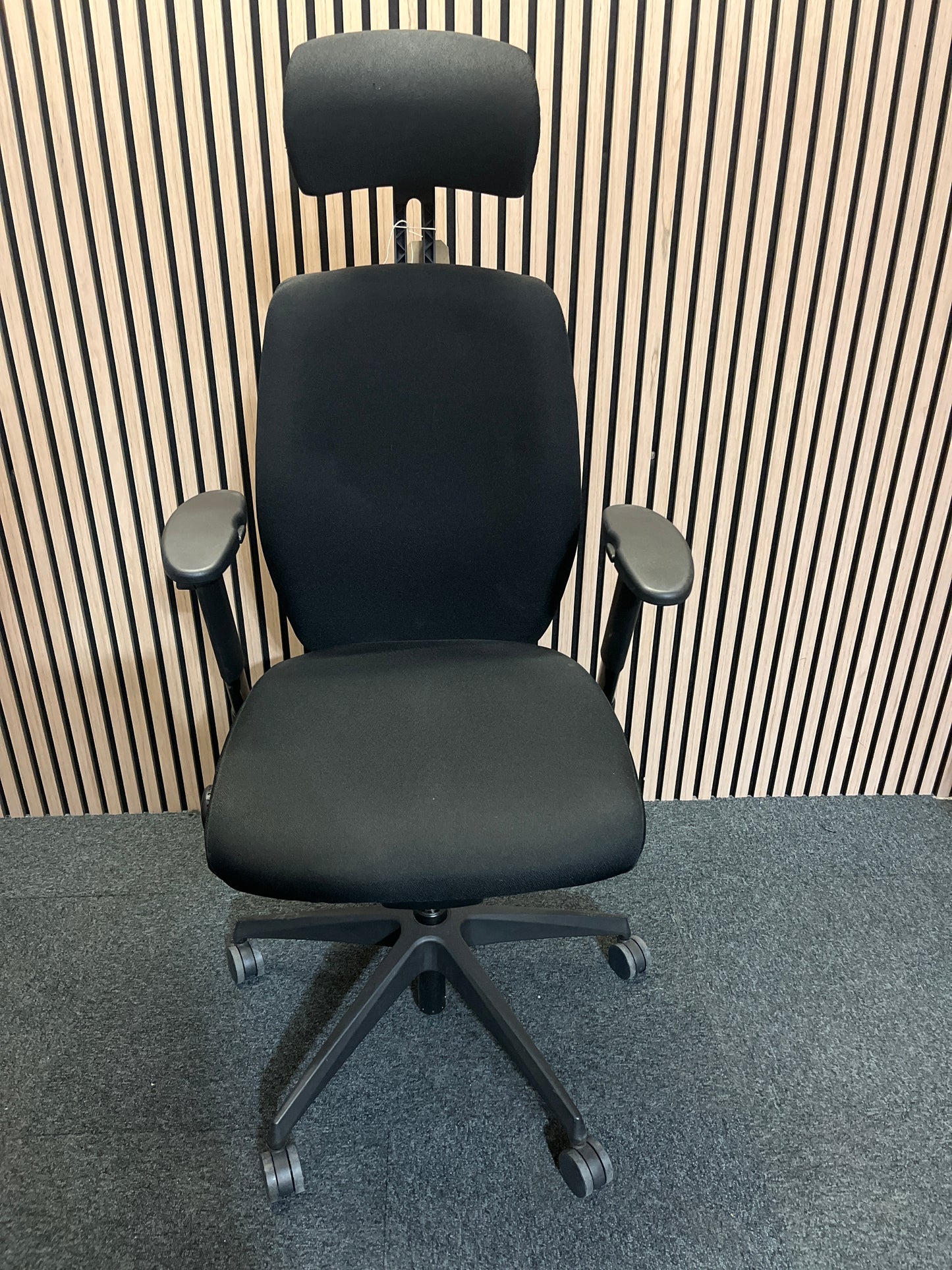 Black fabric fully ortho swivel chair with adjustable arms and high back in black fabric