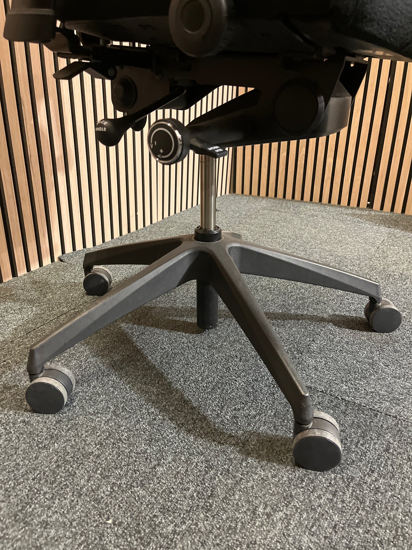 Black fabric fully ortho swivel chair with adjustable arms and high back in black fabric