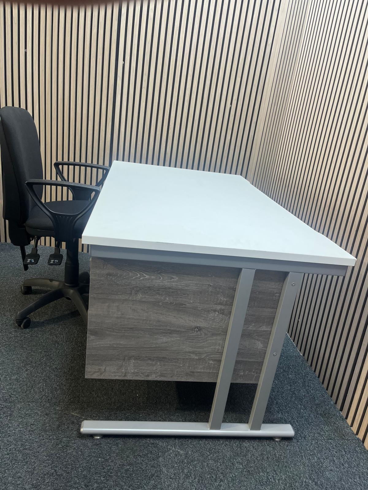 ( GRADE A) White 1400 x 800 desk with grey oak fixed pedestal + (GRADE A) Black fabric swivel chair bundel