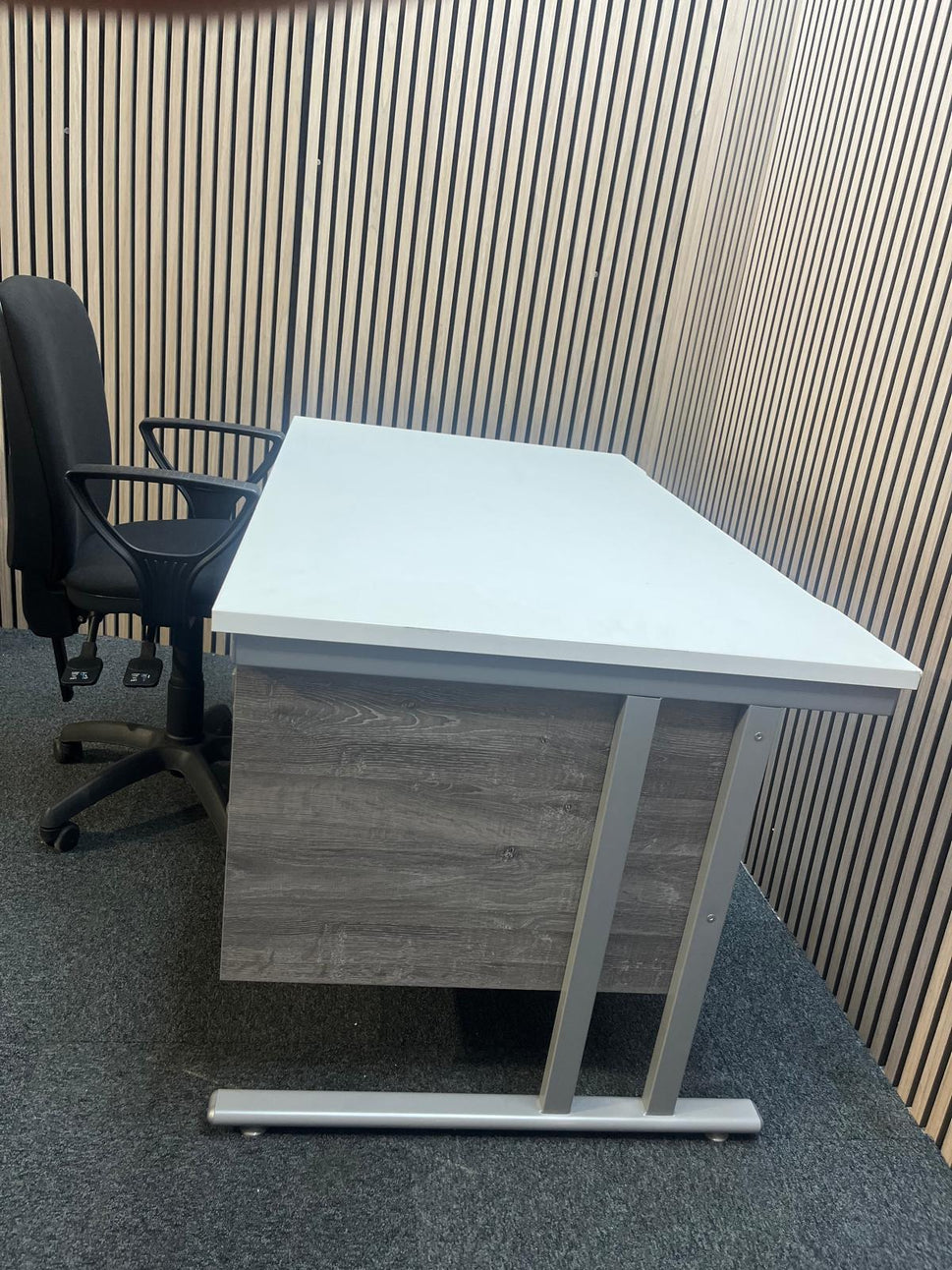 ( GRADE A) White 1400 x 800 desk with grey oak fixed pedestal + (GRADE A) Black fabric swivel chair bundle