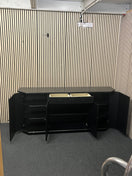 Black low sideboard with three storage doors, good condition. 44030