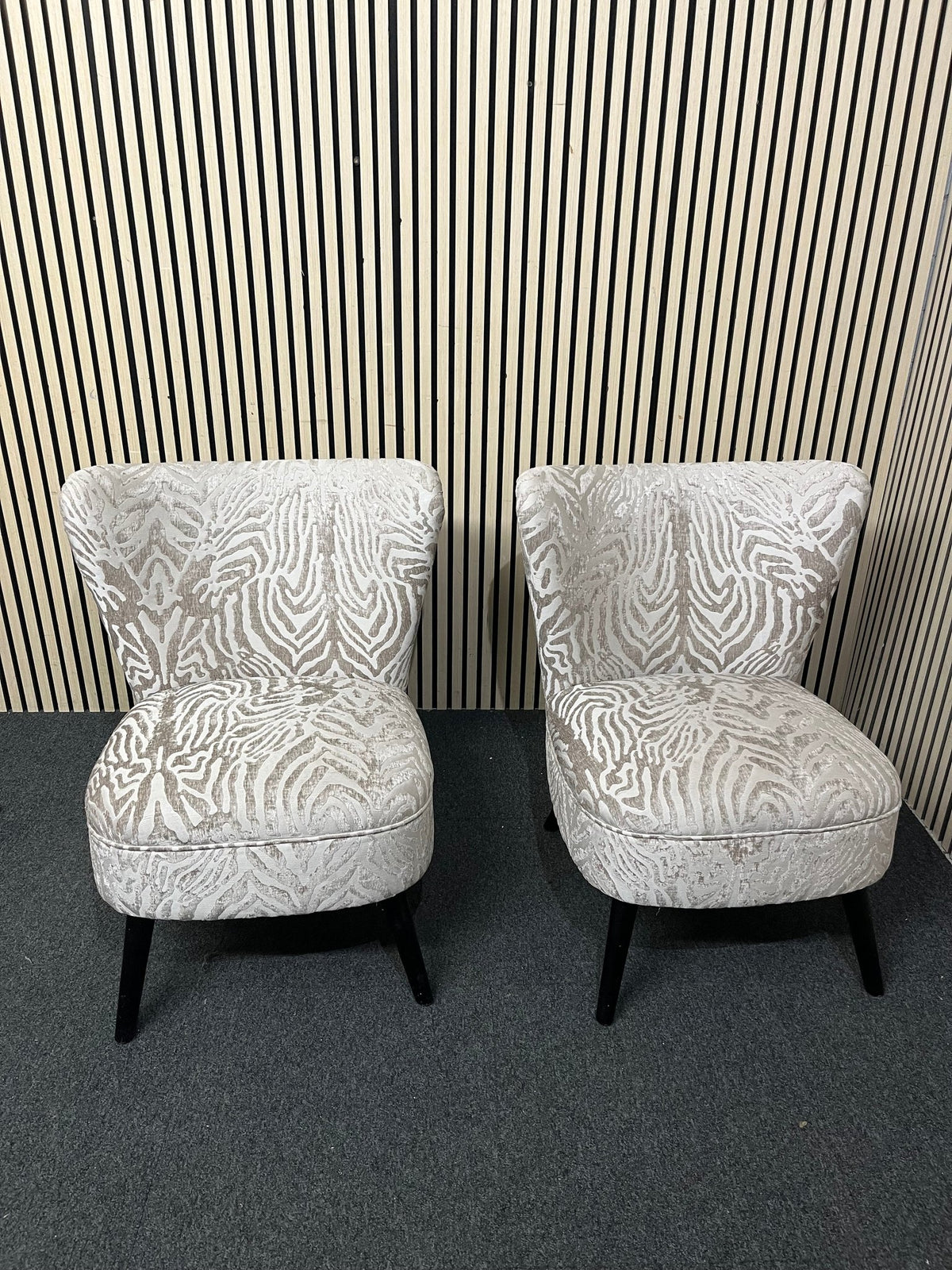Armless accent chair with zebra pattern velvet and black legs.  44354
