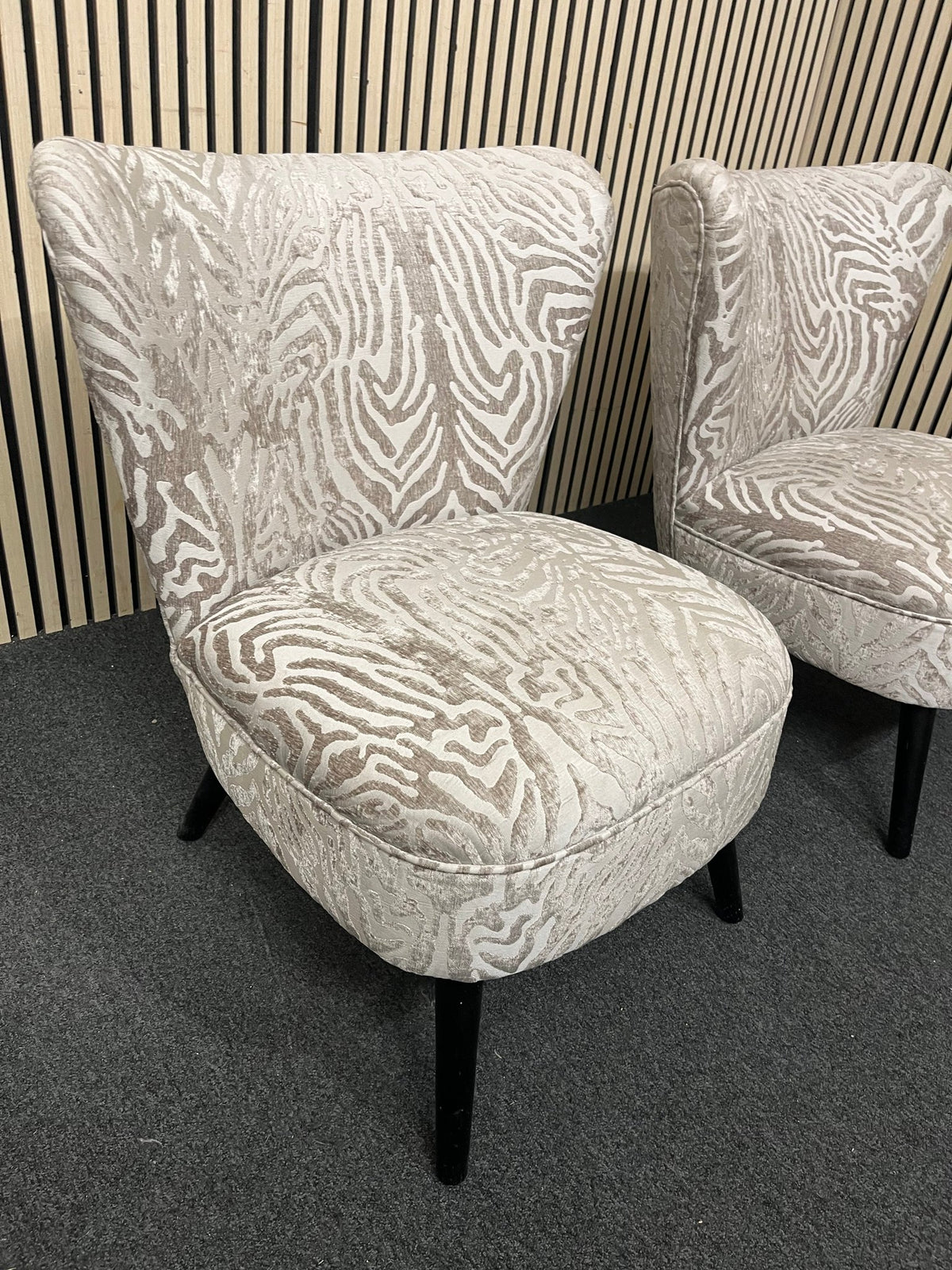 Armless accent chair with zebra pattern velvet and black legs.  44354