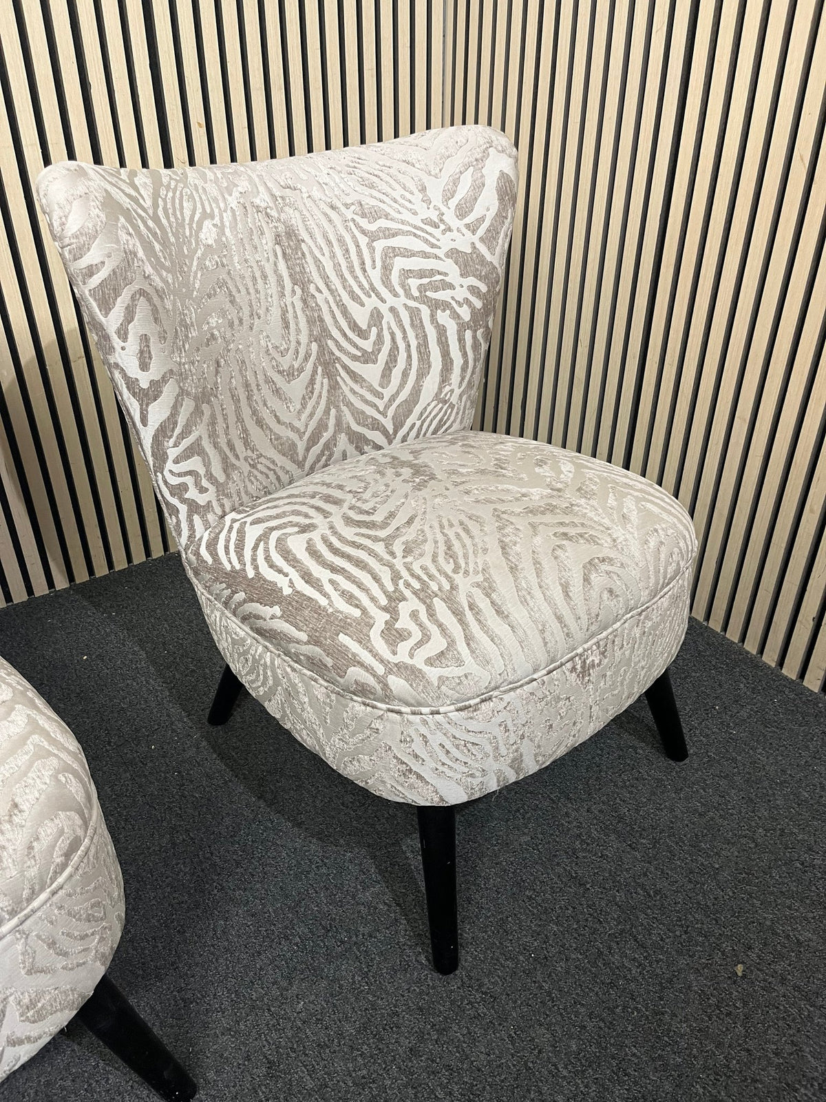 Armless accent chair with zebra pattern velvet and black legs.  44354