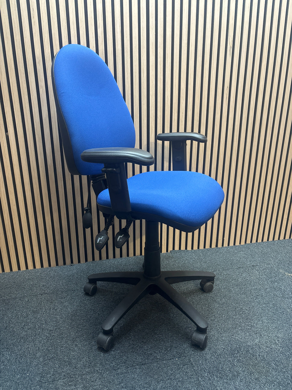 Jota medium back swivel chair in dark blue fabric with pump up lumbar support and height adjustable arms.