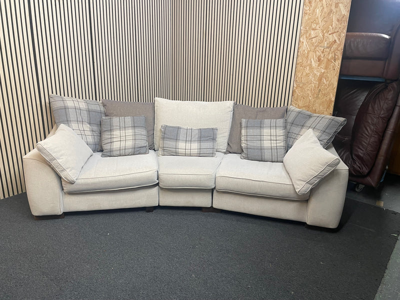 Large curved three-seater fabric sofa with matching scatter cushions.  44592