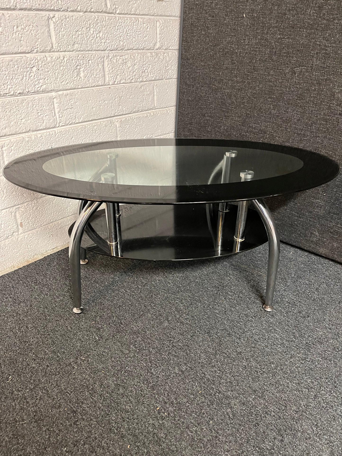 Oval tiered black glass coffee table on chrome legs 1225