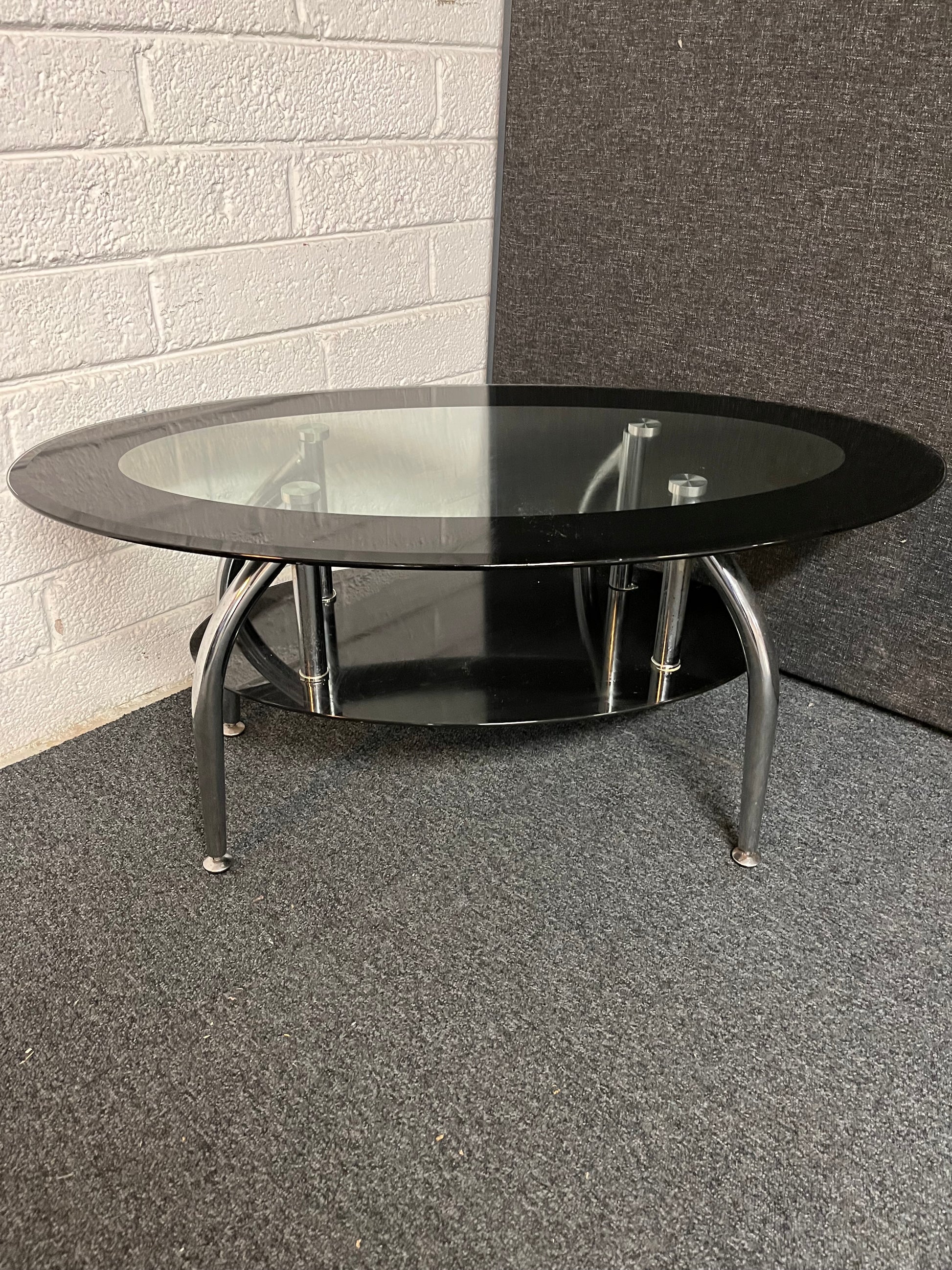 Oval tiered black glass coffee table on chrome legs 1225