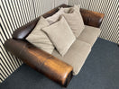 Two-seater sofa with leather frame, fabric cushions, and stud detailin W190x100D  44492