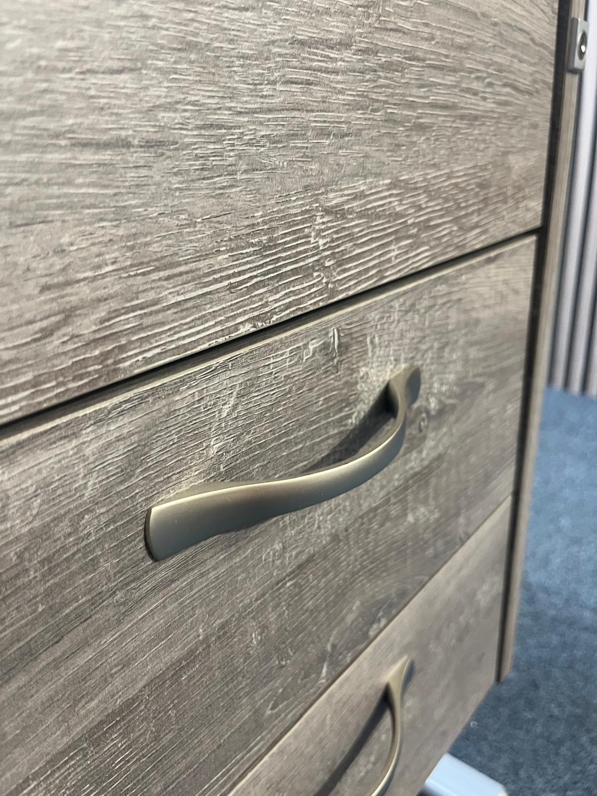 White cantilever framed 1400 x 800 desk with grey oak fixed pedestal and modesty panel