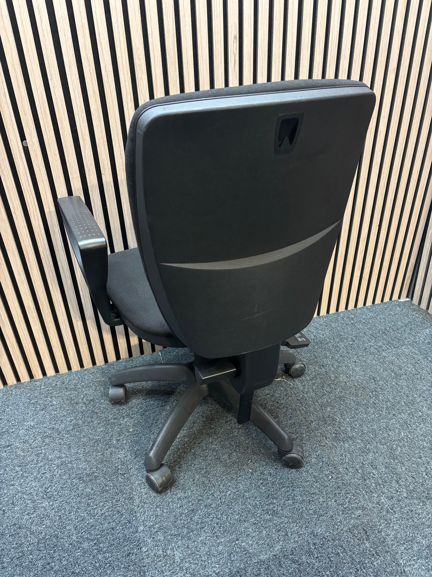 Black fabric swivel chair with black plastic fixed arms and 5 star swivel base
