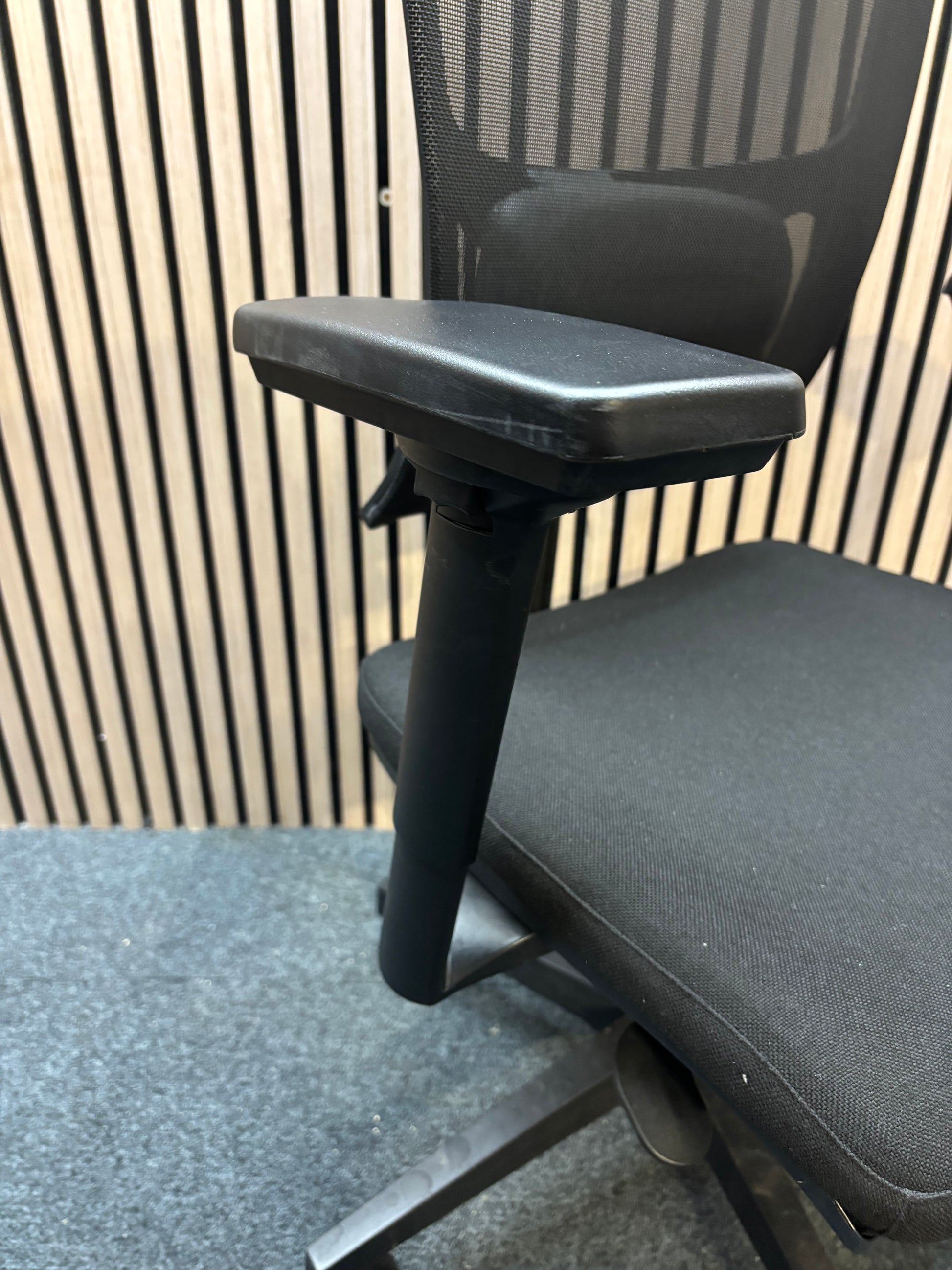 Black mesh back swivel chair with adjustable arms and 5 star swivel base
