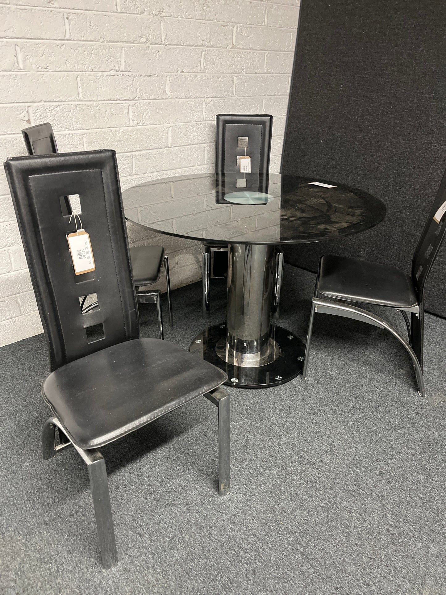 Black glass circular kitchen table (radius x 1060 mm), central base with 4 no. high back black leatherette and chrome dining chairs  1225