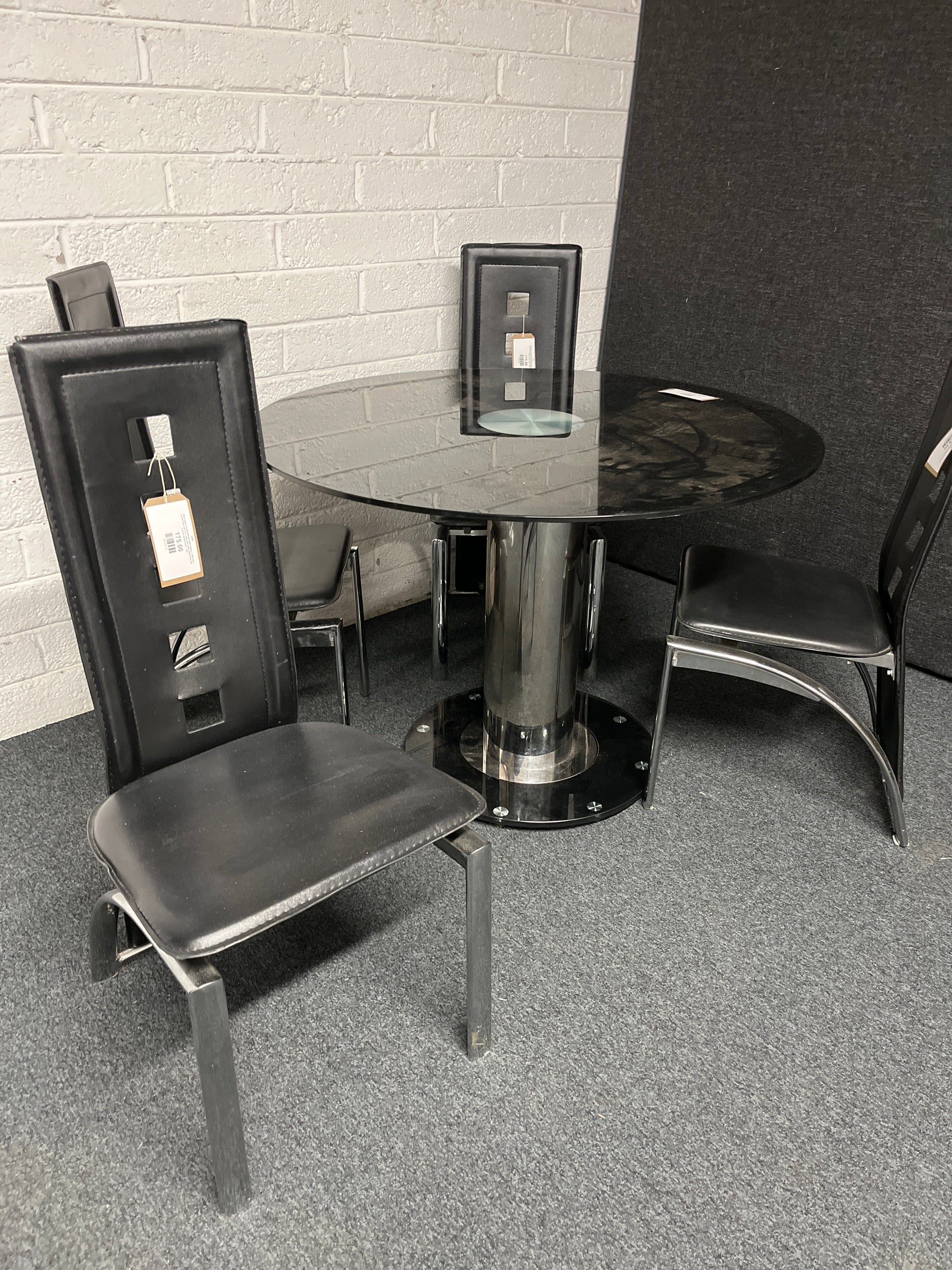 Black glass circular kitchen table (radius x 1060 mm), central base with 4 no. high back black leatherette and chrome dining chairs  1225