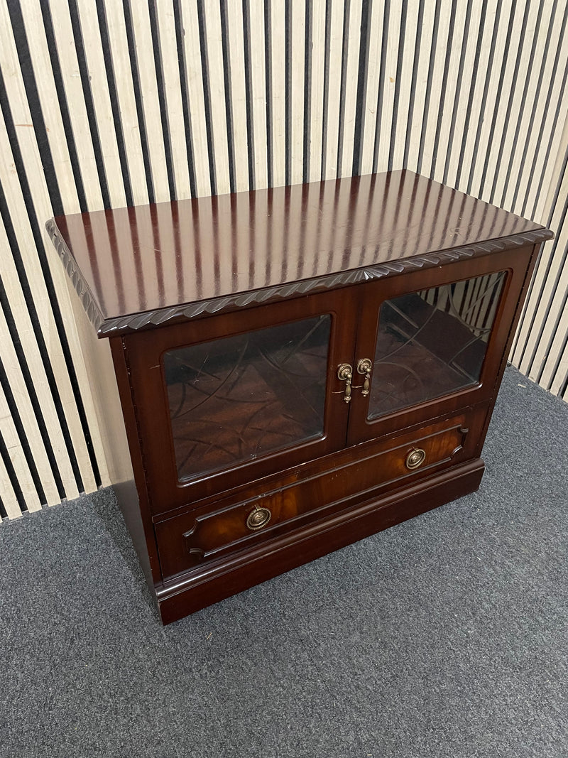 Dark wood TV unit with leaded glass doors and drawers.  44509