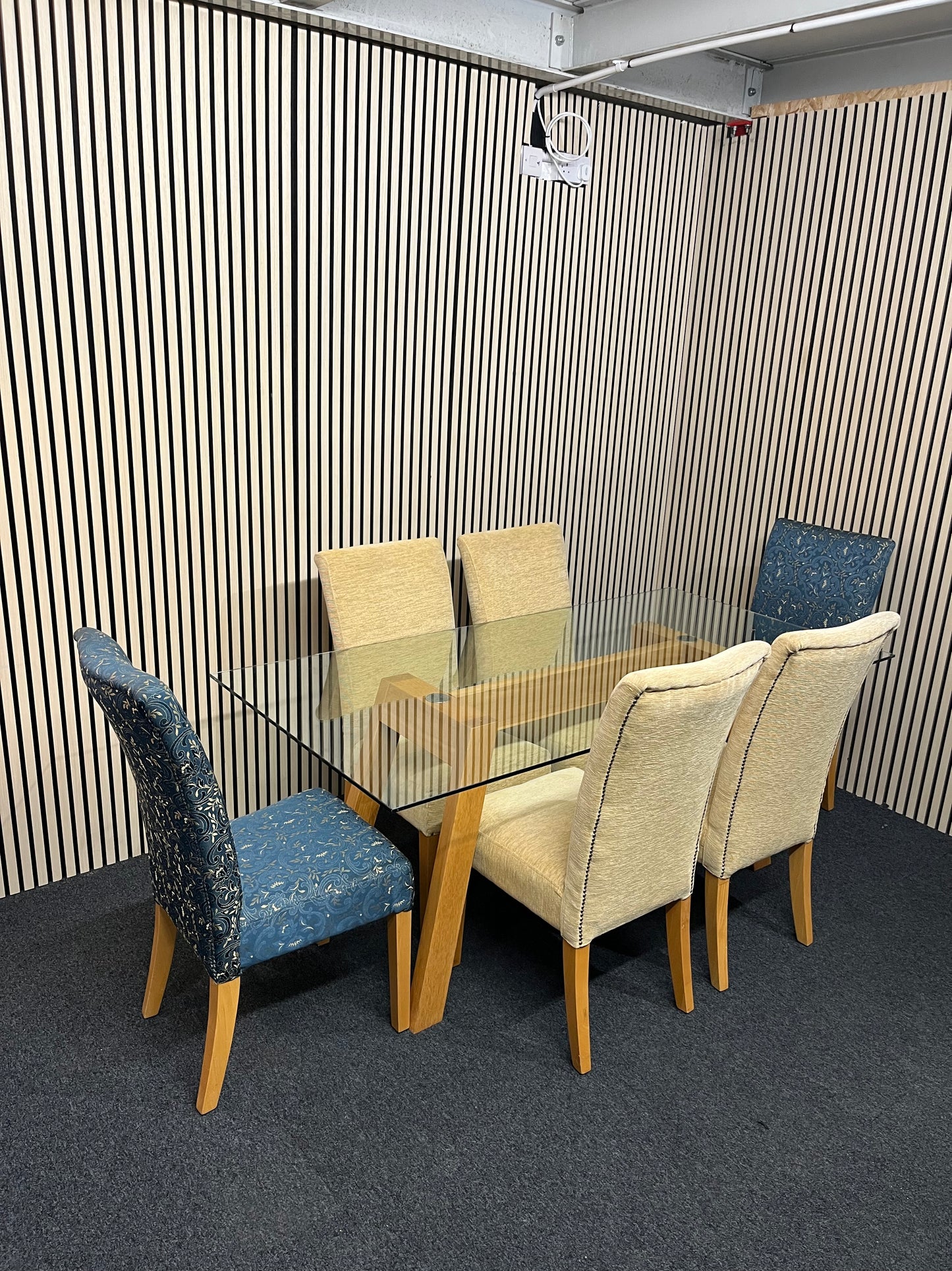 Long glass rectangular dining table(W 180 x D 90 cm) with 4 no. high back brown fabric dining chairs and 2 no. navy and gold fabric end chairs