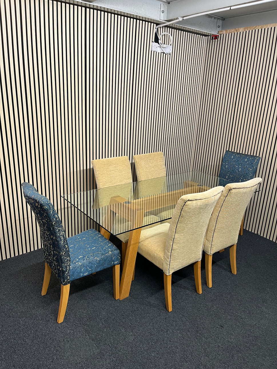 Long glass rectangular dining table(W 180 x D 90 cm) with 4 no. high back brown fabric dining chairs and 2 no. navy and gold fabric end chairs