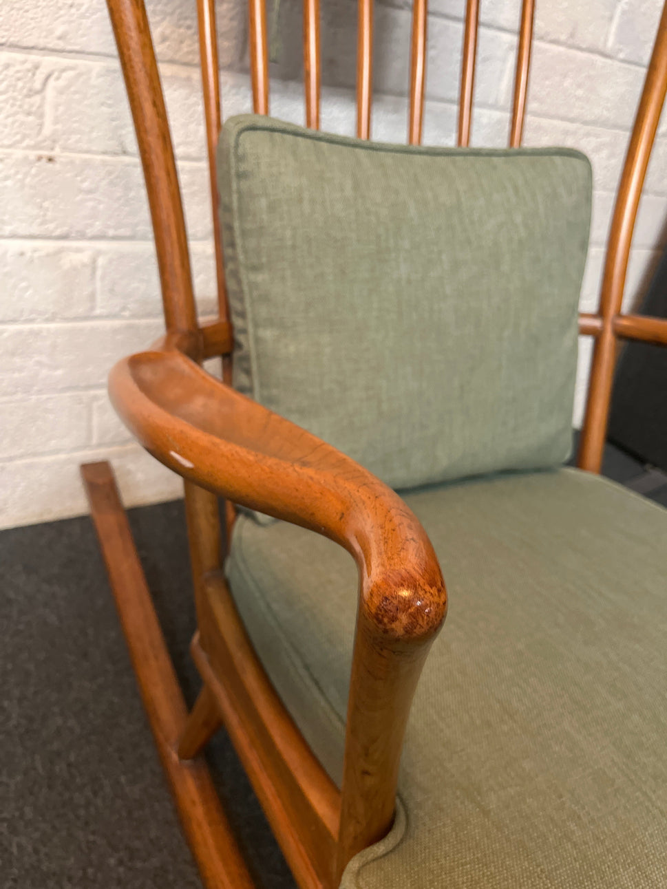 Solid oak high back ornate rocking chairs with sea green fabric seat cushion and back. Missing one spindle on the back  2225