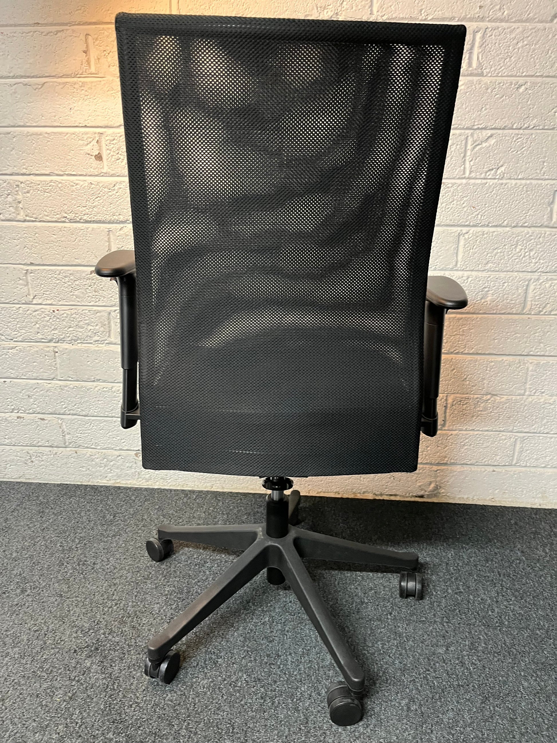 SECONHAND Black fabric seat, black mesh back swivel chair with multifunction and height adjustable arms. IN EXCELLENT CONDITION