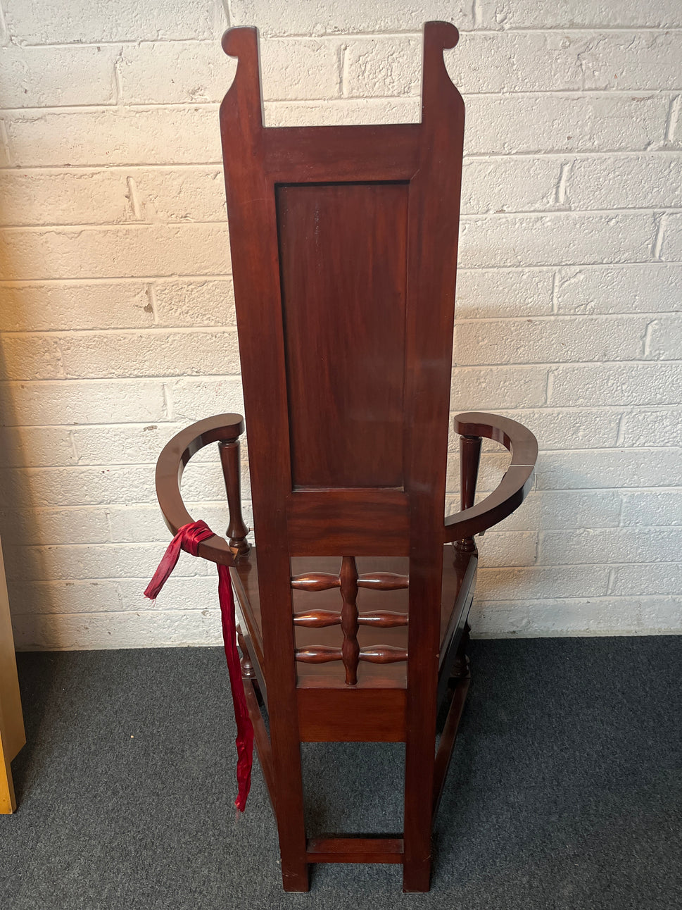 Solid teak polished stained occasional high back armchair. One arm with damage to side but repaired 2225