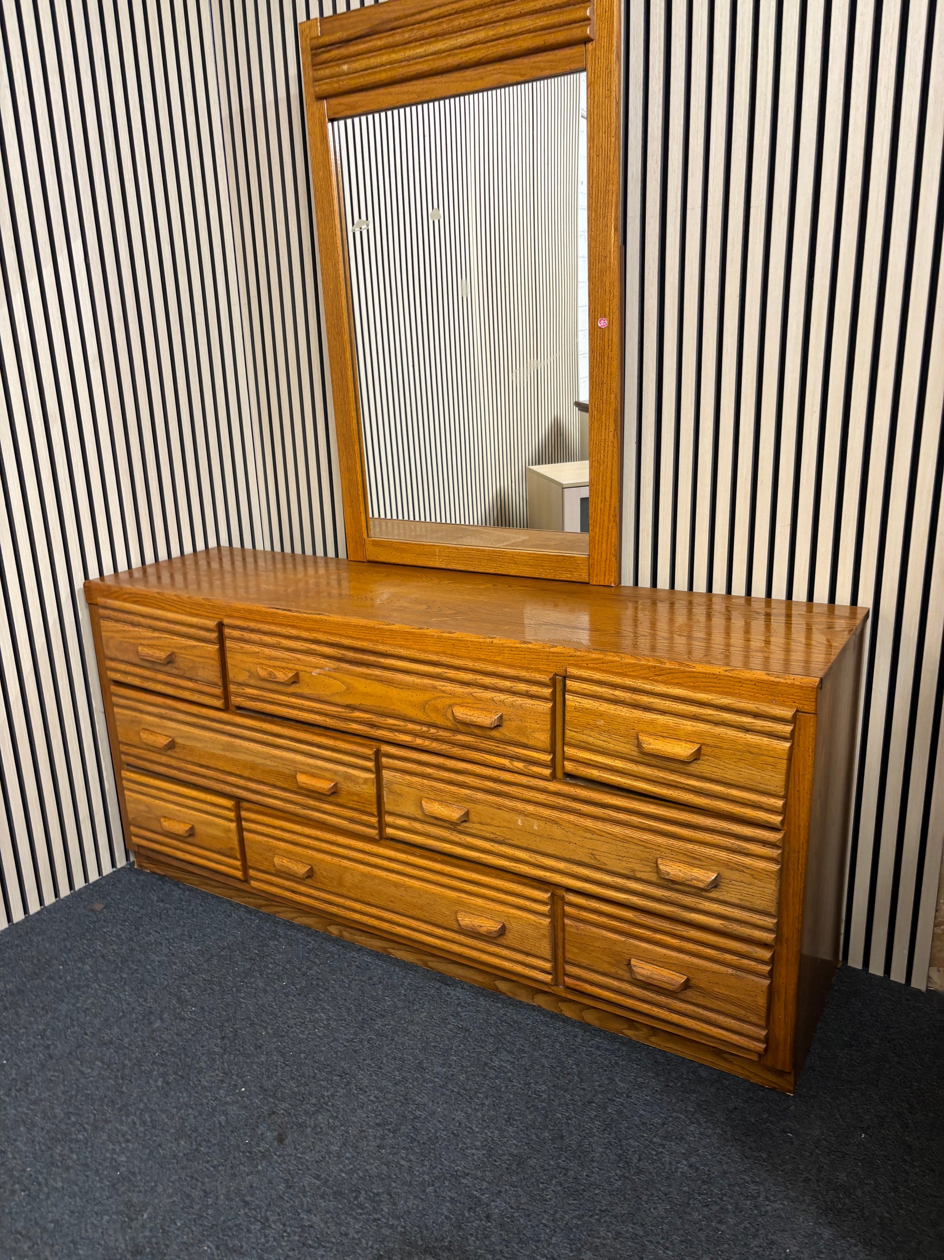 Large wooden 8 door dresser with a matching framed mirror
