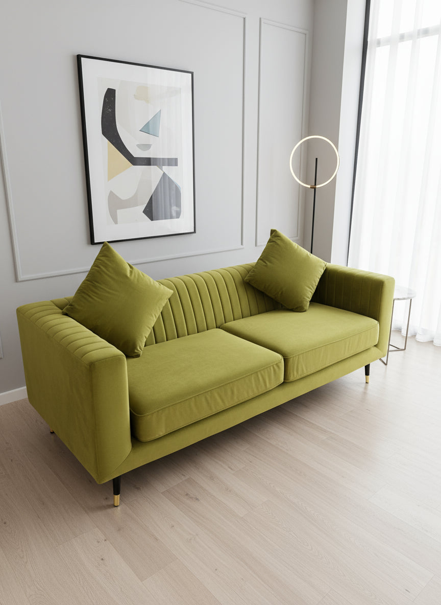 Modern olive green velvet sofa with vertical channel tufting, 2 seat cushions and slim black legs assencted with gold tips( W x 197 L x 81 H x 73 cm)