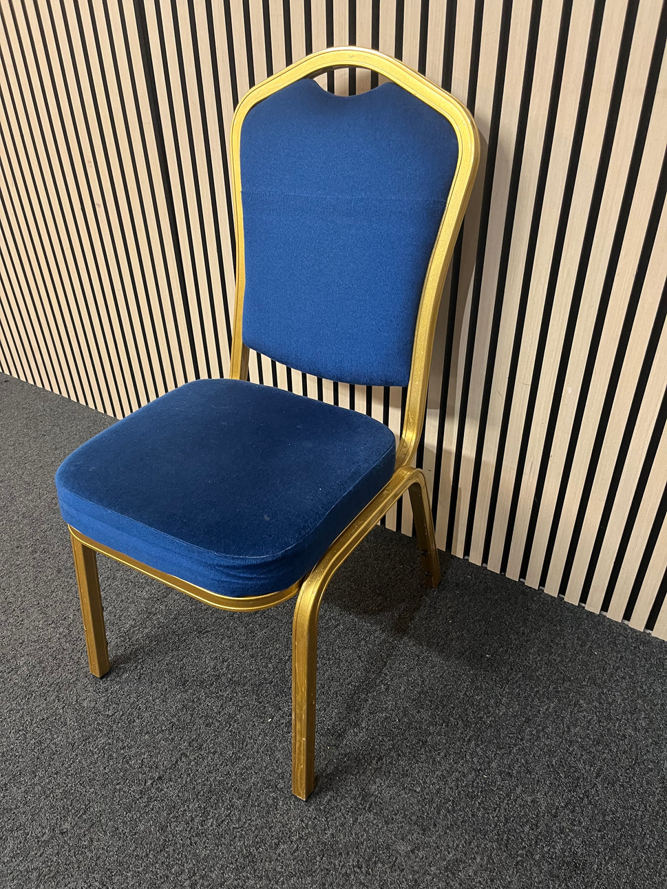 Blue fabric metal framed gold effect stacking banquet chair with curved top