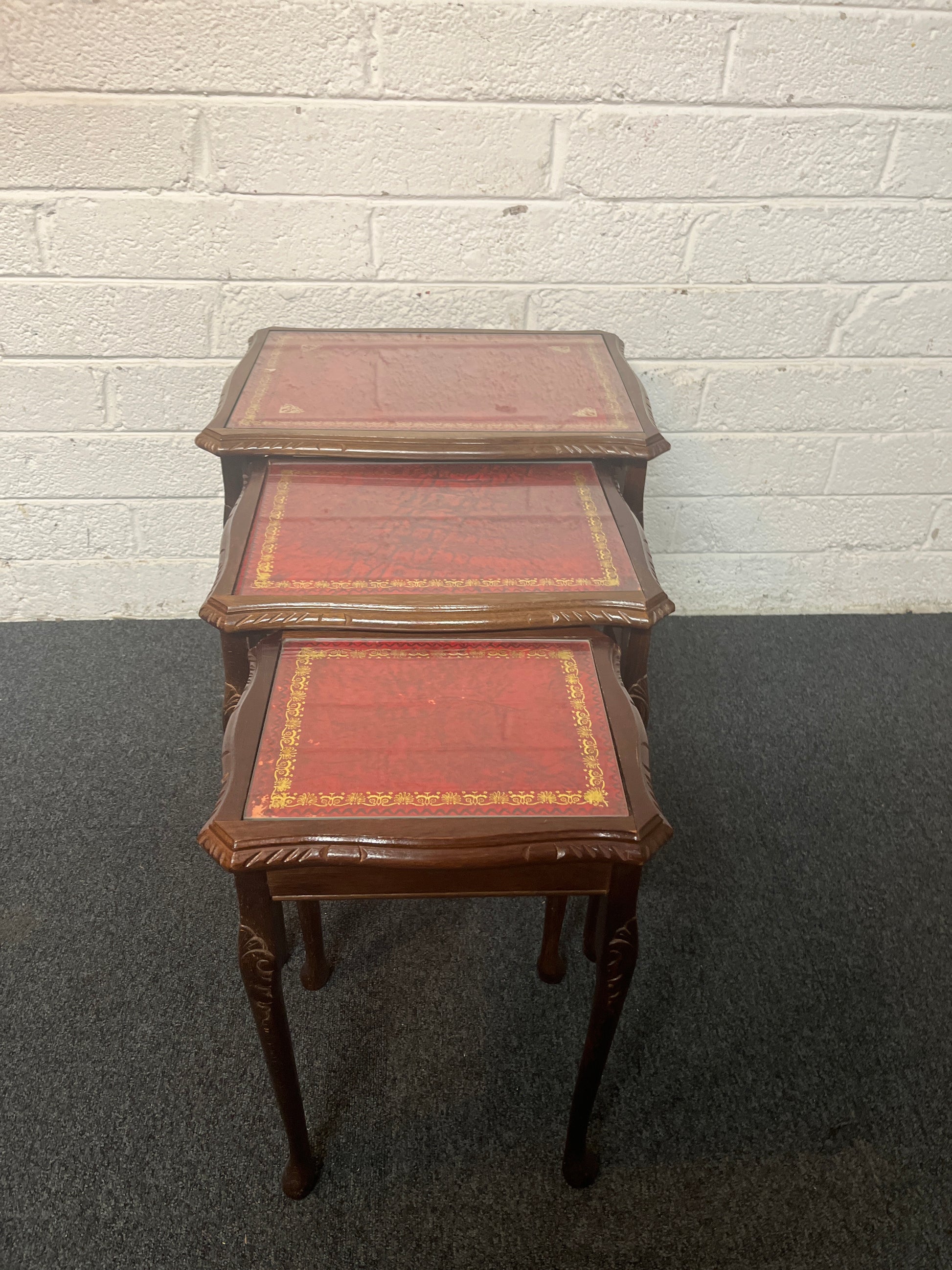 Mahogany nest of tables with glass top and carved detailing 1325