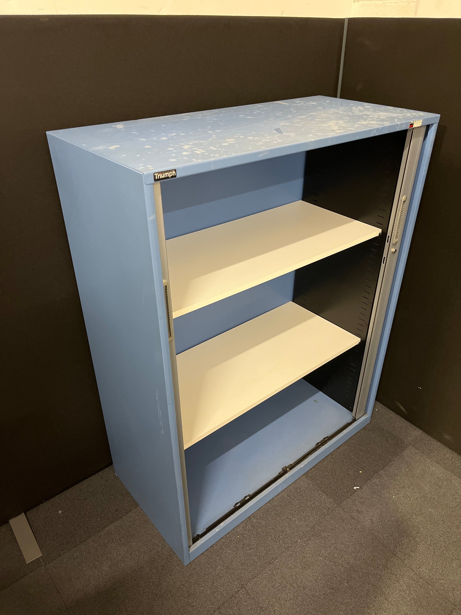 Secondhand Triumph Blue metal framed, silver plastic sliding door tambour  with 2 no. internal shelves and 1 no. key 1000Wx1290Hx475D