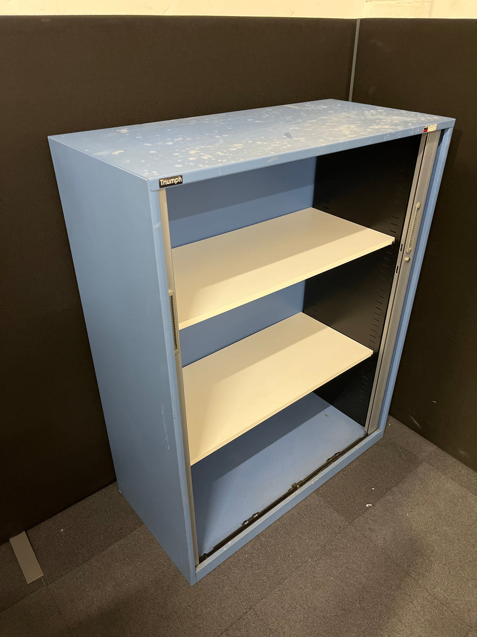 Secondhand Triumph Blue metal framed, silver plastic sliding door tambour  with 2 no. internal shelves and 1 no. key 1000Wx1290Hx475D