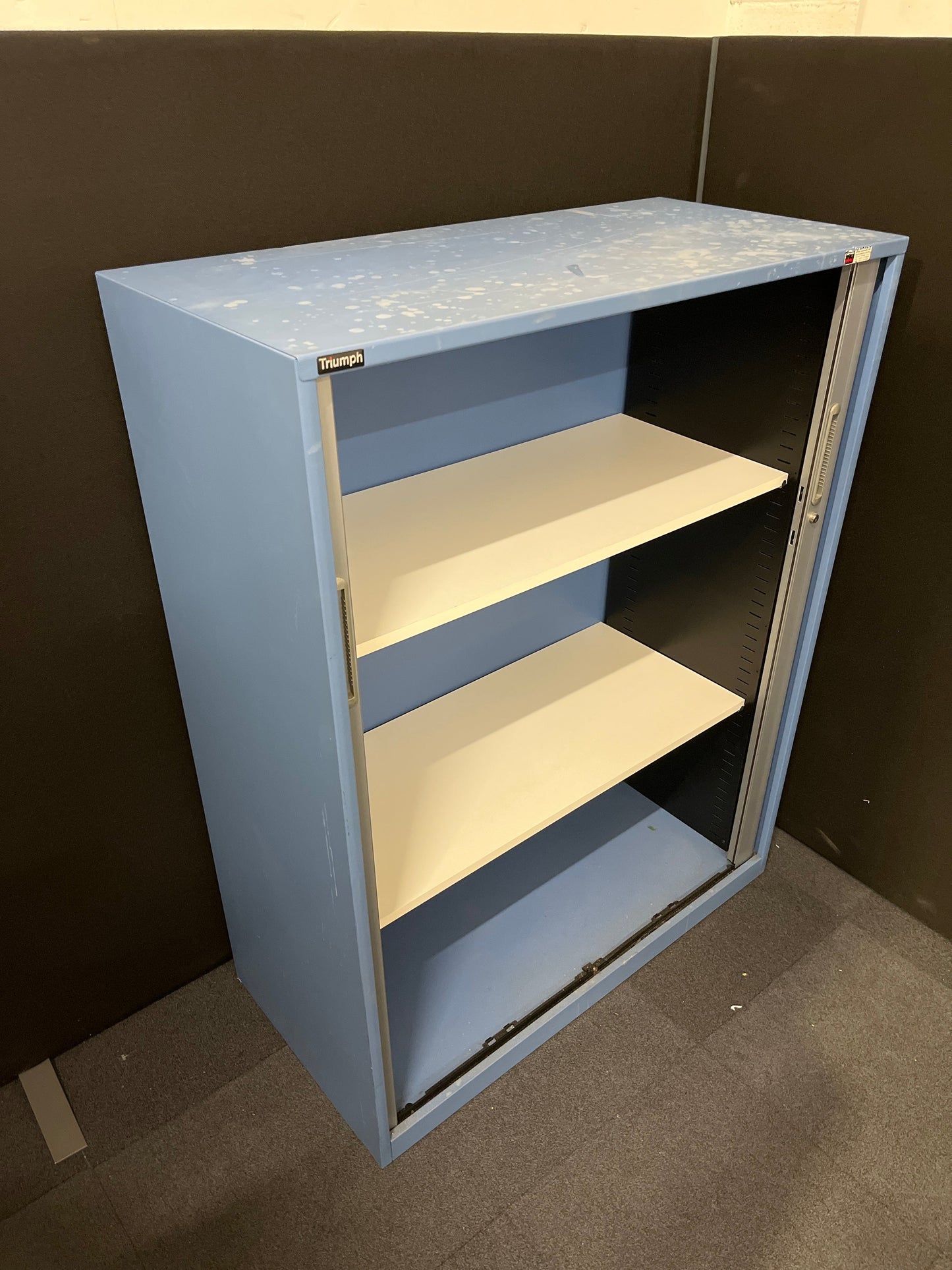 Secondhand Triumph Blue metal framed, silver plastic sliding door tambour  with 2 no. internal shelves and 1 no. key 1000Wx1290Hx475D